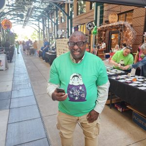 Artist Perry Johnson posing for a picture at the 2024 So Small Miniature Art Auction