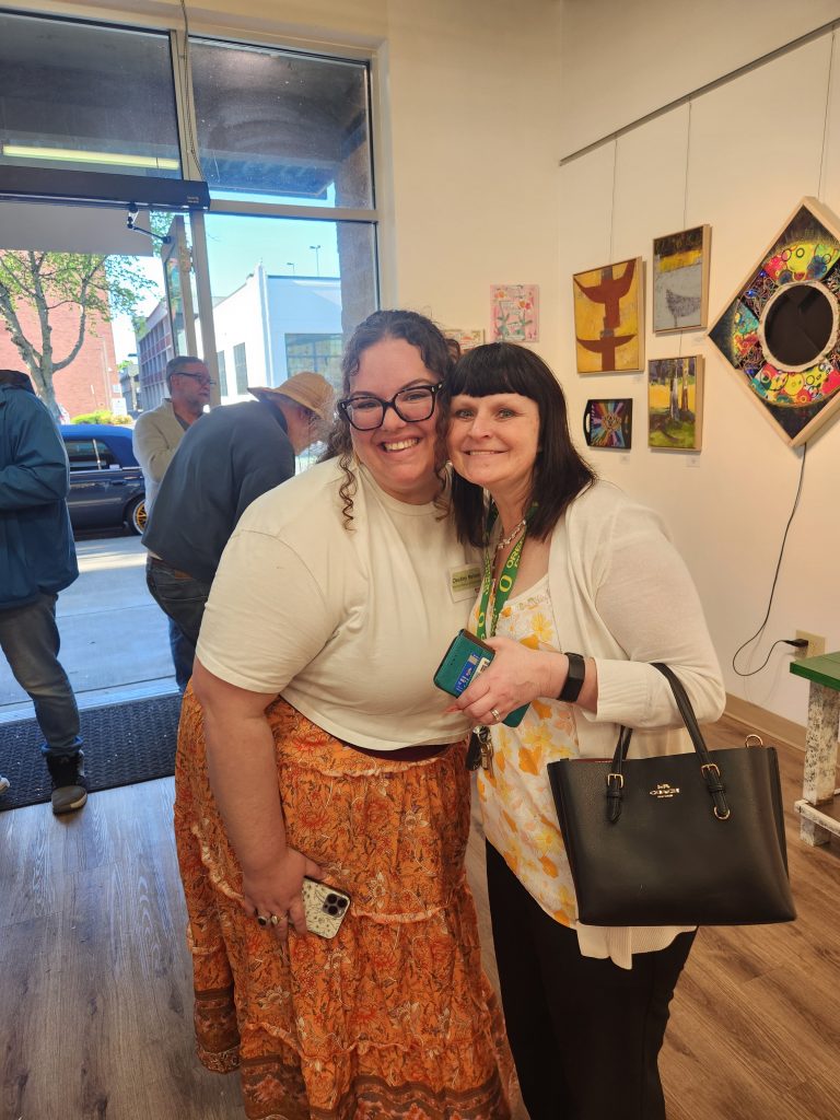 two people posing for a photo at the Radiant Community Arts launch party